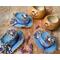 This image shows the carved pumpkin gourds sitting next to their handmade hats. The hats are made using up-cycled jeans.